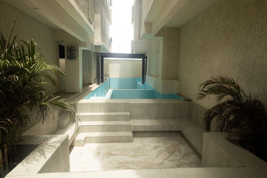 Brum Height 7: Poolside approach with tiled steps and planted borders